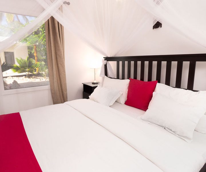 Bed with garden view at White Hotel Zanzibar